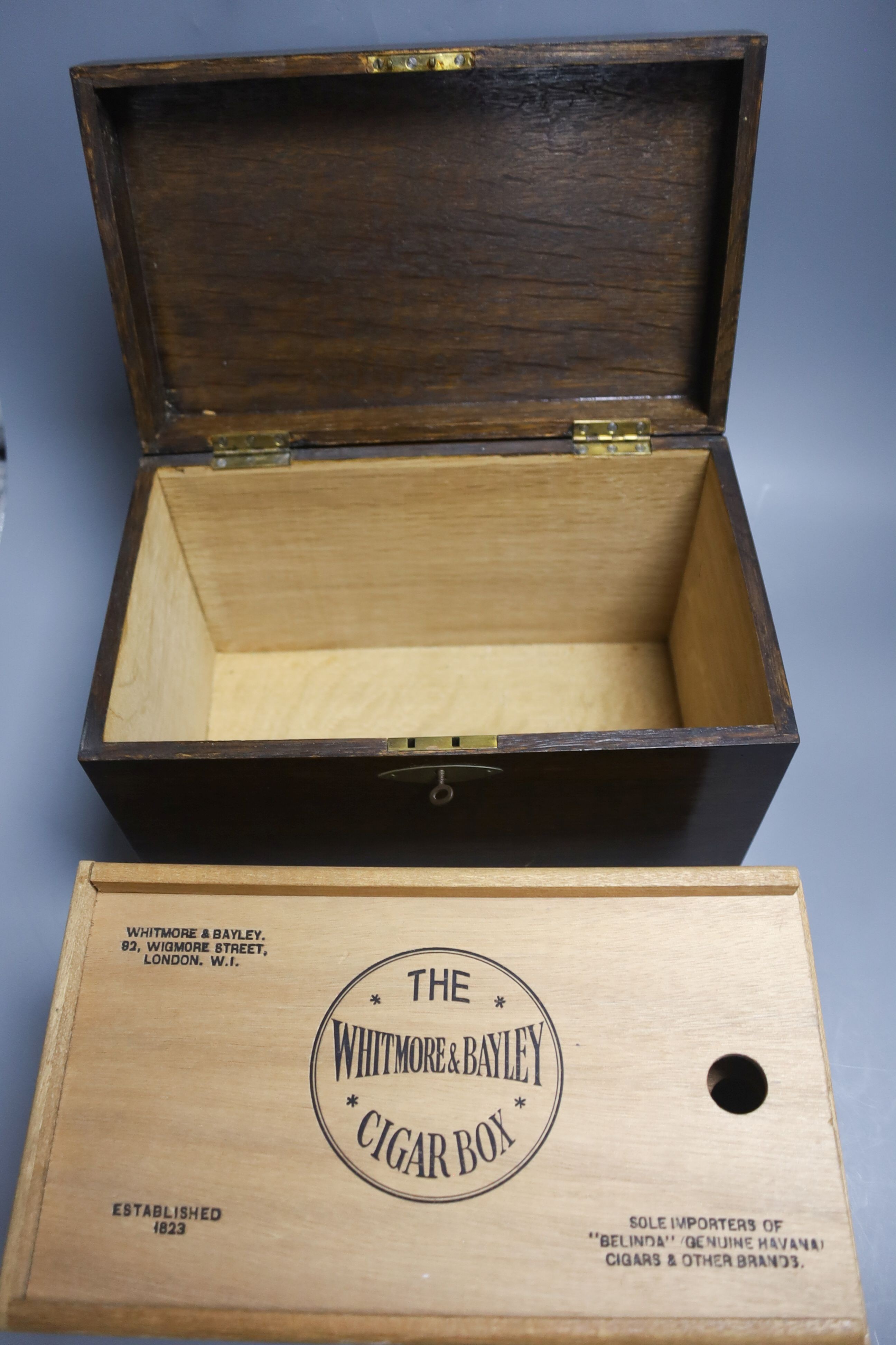 A Whitmore & Bayley oak cigar box and cigars, 1920s, some tubes empty